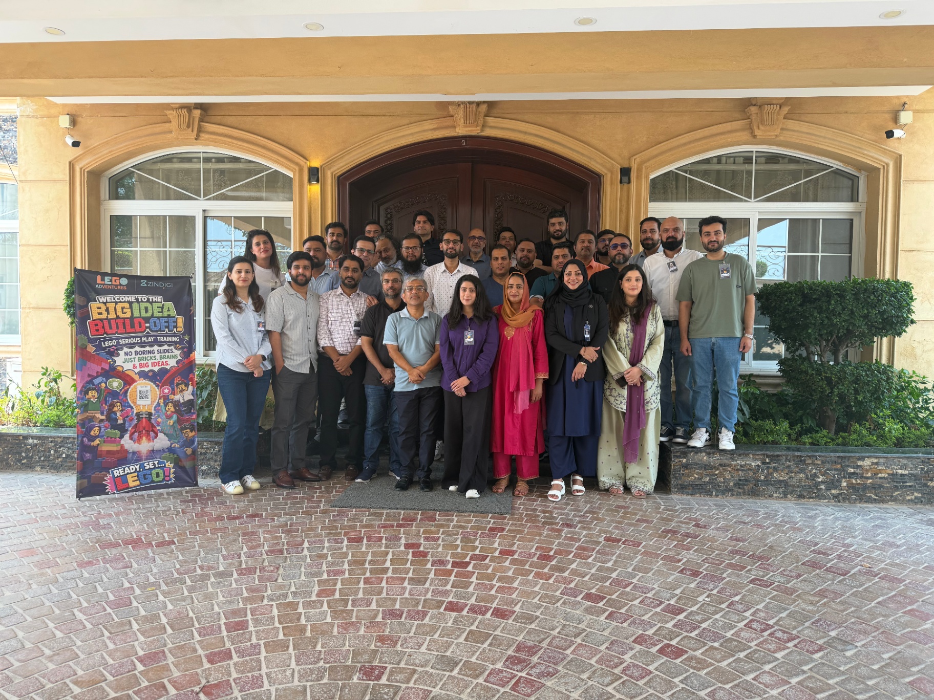 Participants of an AVA LEGO Serious Play workshop gathered for a group photo.